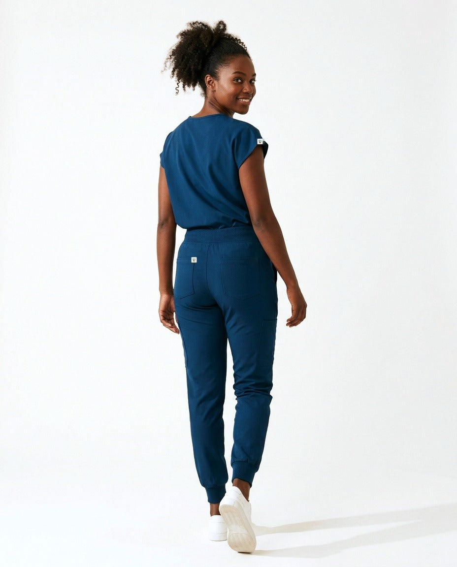 Women's Contour mandarin-collar top and Motive jogger pants scrub set in Blue – back view | Threadicine
